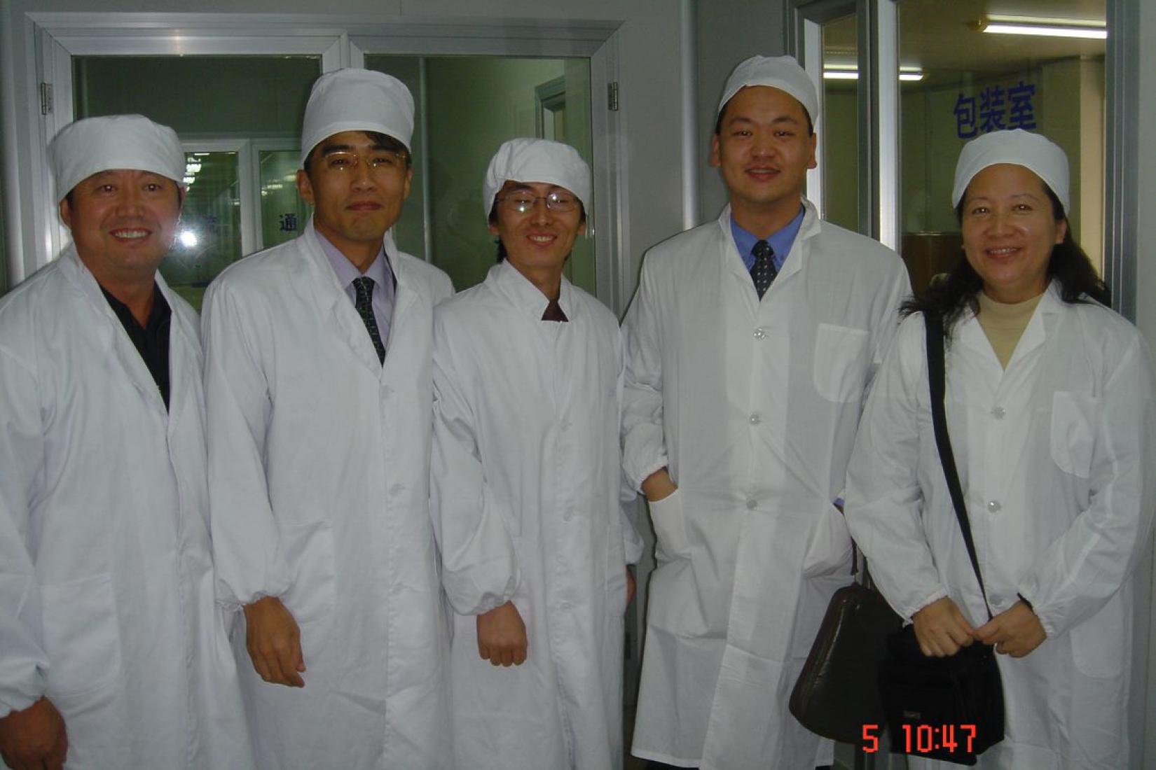 In a food factory with union chair and tripartite delegation, Nanjing, 2004