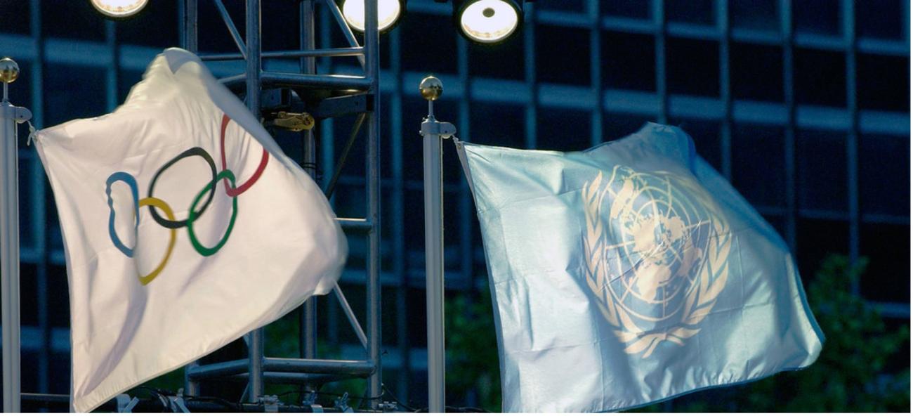 The United Nations and the Olympic flags raised at UN Headquarters. /UN Photo/Evan Schneider