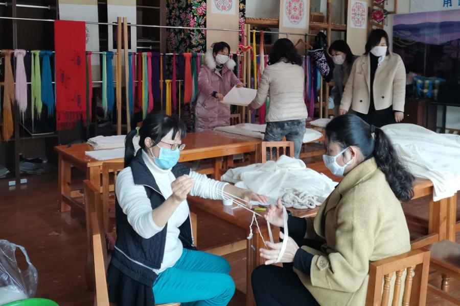 Members of the Women Embroidery Farmers Cooperative make masks at the cooperative centre.